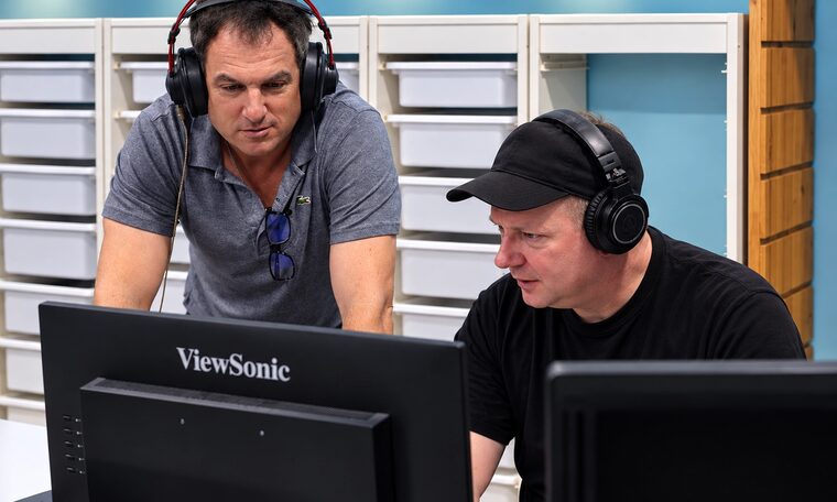 Two Forever Studios technicians listening back to an audio transfer at the monitors