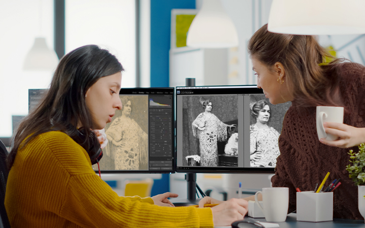 Forever Studios team reviewing photo restoration results