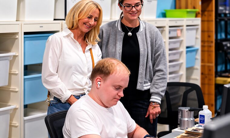 Two Forever Studios team members reviewing scans over a technician's shoulder