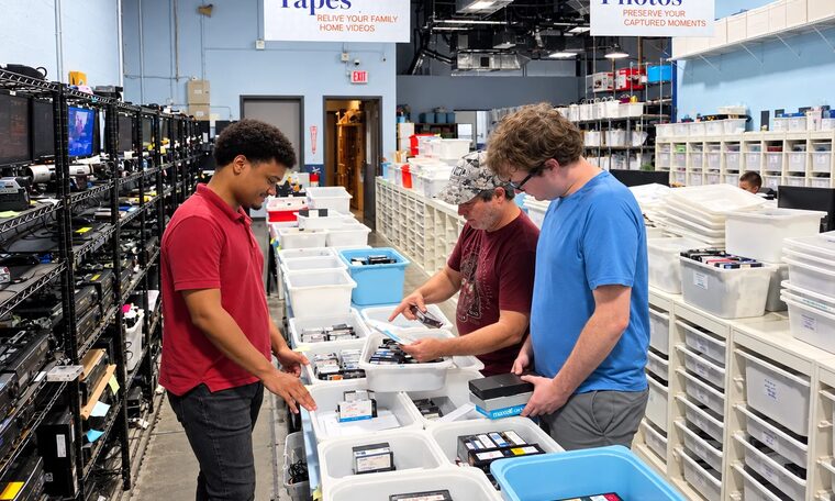 Forever Studios staff sorting customer tapes into bins in the tape room