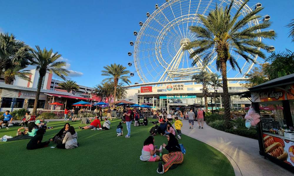 The Wheel rising above the palm trees and lawn at ICON Park on International Drive in Orlando