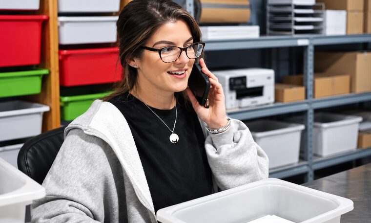 A Forever Studios staff member on the phone at the intake desk
