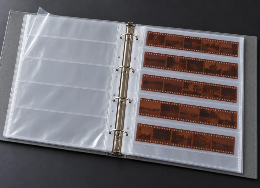 Film negative storage binder with protective sleeves and organized strips