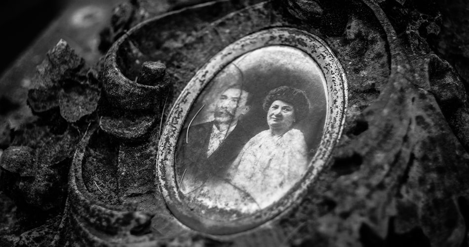 Vintage photograph adhered to picture frame glass due to humidity exposure