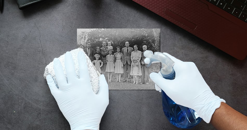 Soft natural-bristle brush removing surface dust from vintage photograph edge